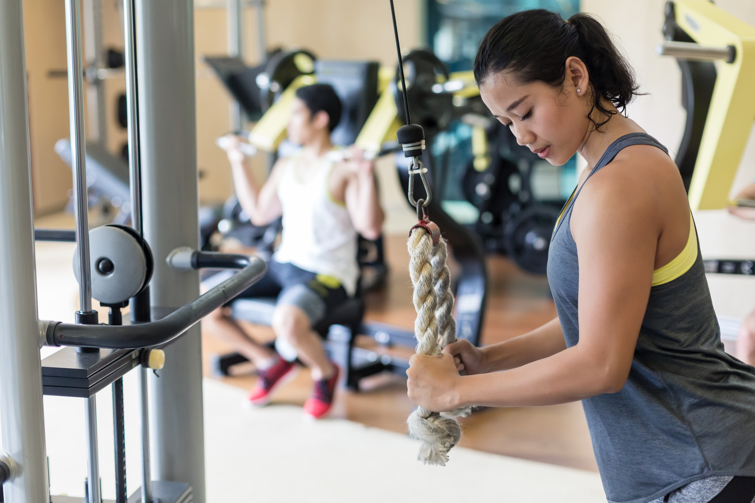 Cable Tricep Pushdown - woman doing exercise in gym