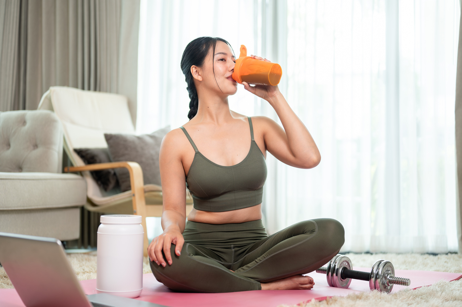 Muscle Recovery - woman drinking protein shake after workout