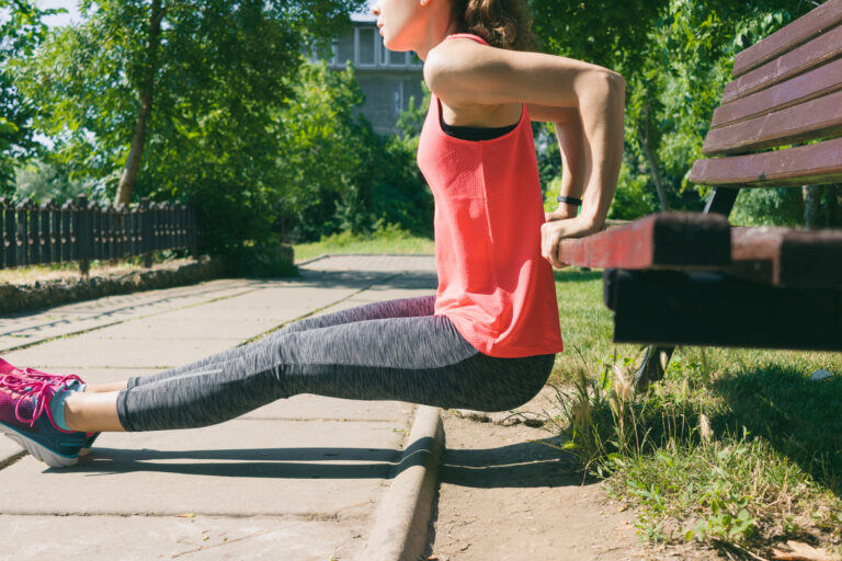 What Do Dips Work - woman in park doing dips on bench